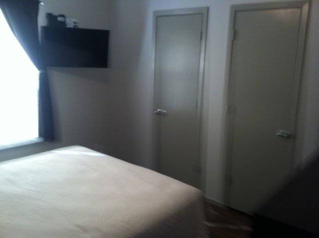 Bedroom with wall-mounted television